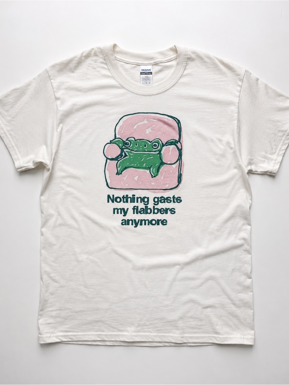 White Short-Sleeve Tee with Pink Chair and Green Frog Graphic